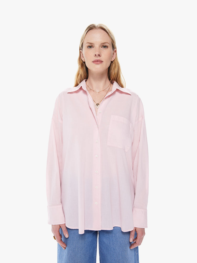 Front view of a women's light pink button down shirt featuring long sleeves, a single chest pocket, and an oversized fit.