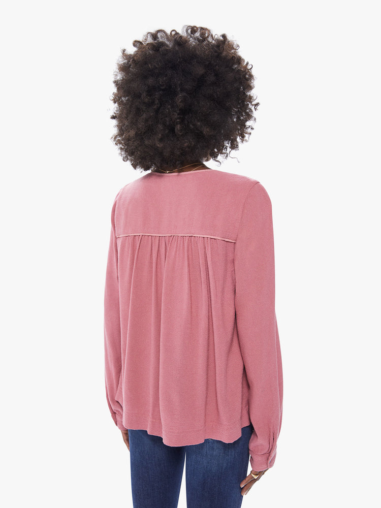 Back view of a women's deep pink long sleeve blouse, featuring a flowy fit and a keyhole neck with tie.