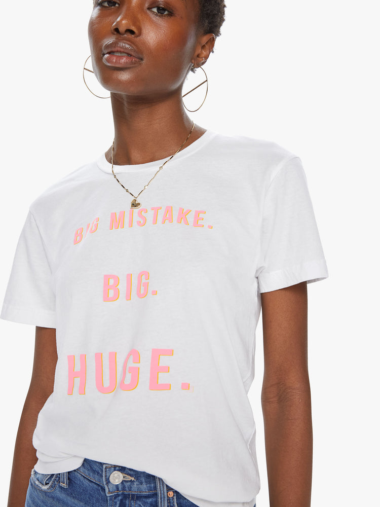 Front detail view of a women's white t-shirt featuring a pink graphic which reads "BIG MISTAKE. BIG. HUGE"