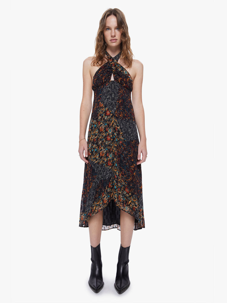 Front view of a womens dark printed dress featuring a a halter neck and an empire waist.