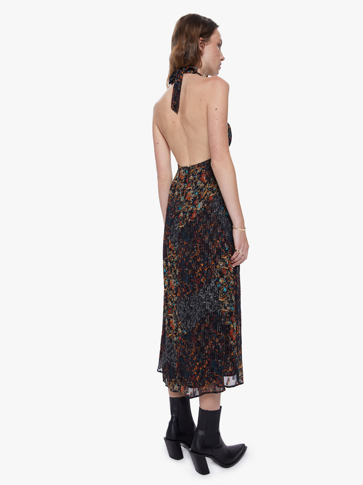 Back view of a womens dark printed dress featuring a a halter neck and an empire waist.
