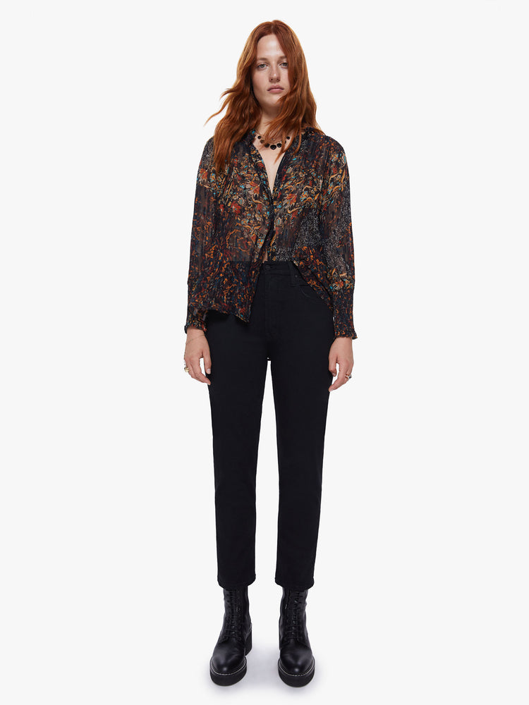 Front full body view of a womens dark printed button down blouse featuring loose long sleeves with smocked cuffs and a flowy fit.