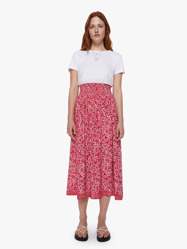 Front view of a woman wearing a floral maxi skirt with a smocked waistband and loose flowy fit