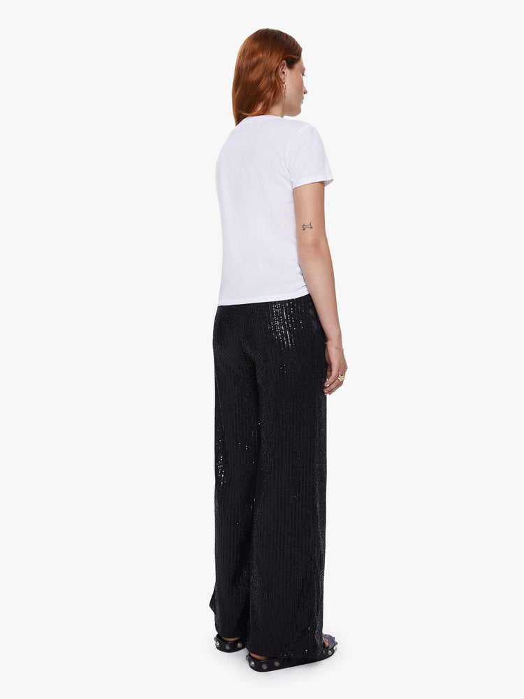 Back view of a womens wide leg pants featuring black sequins, a high rise, and a flowy fit.
