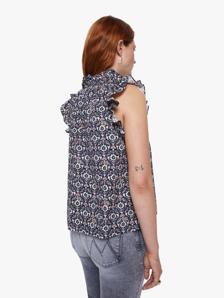 Back view of a womens sleeveless top featuring a grey print, v neck, ruffles along the armholes, and a boxy fit.