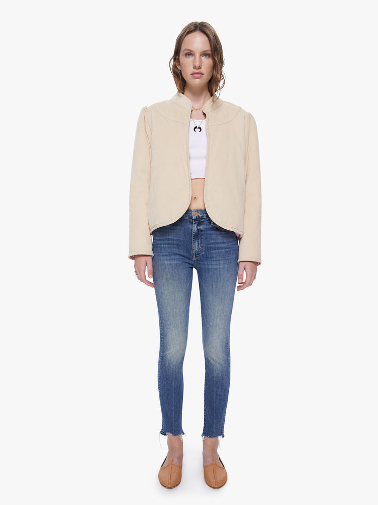 Front full body view of a womens beige jacket featuring a beige trim and a cropped boxy fit.