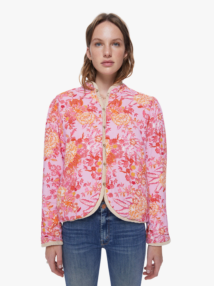 Front view of a womens pink floral jacket featuring a beige trim and a cropped boxy fit.