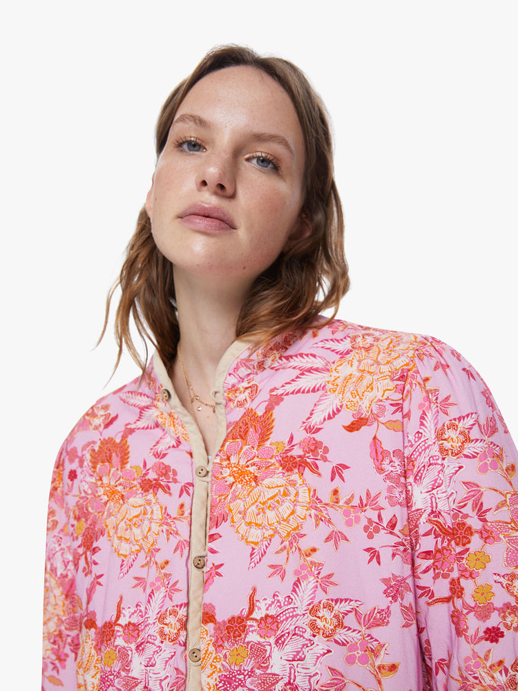 Front close up view of a womens floral jacket featuring a beige trim and a cropped boxy fit.