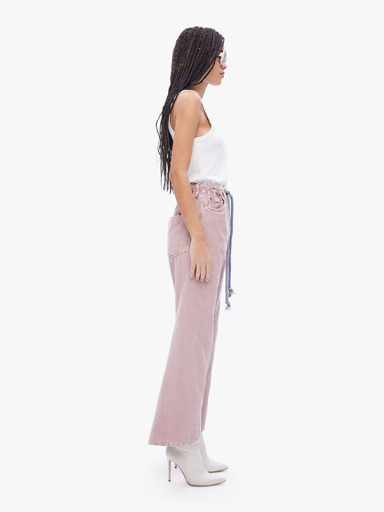 Side view of a womens dusty pink pant featuring an oversized relaxed fit and a drawcord.