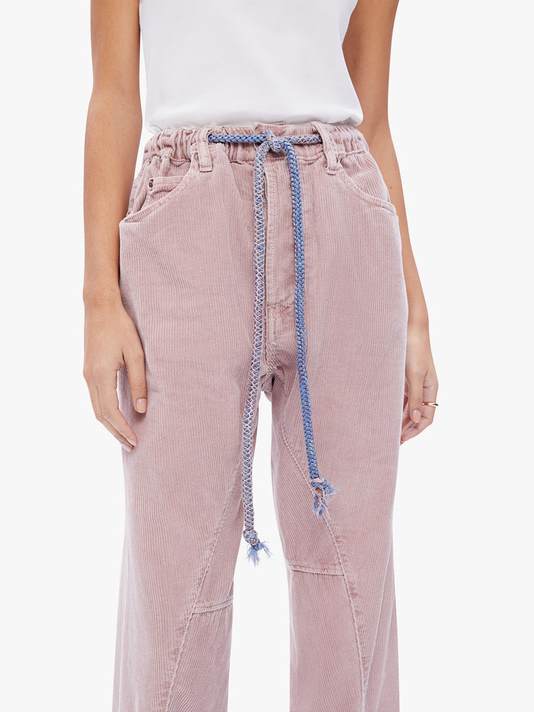 Front close up view of a womens dusty pink pant featuring an oversized relaxed fit and a drawcord.