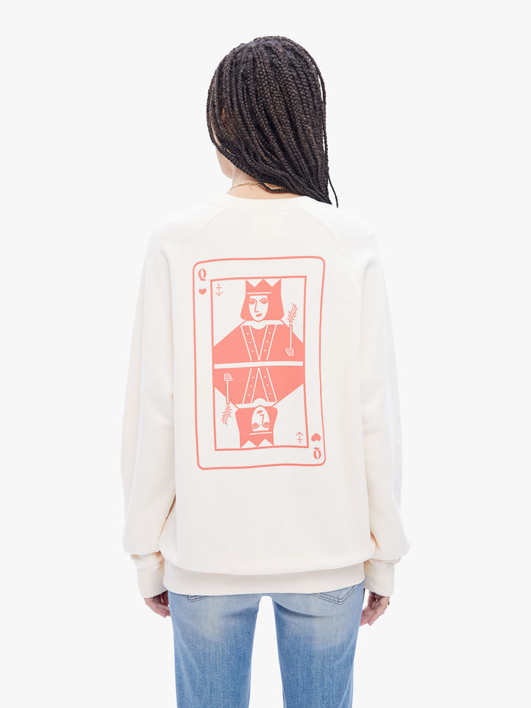 Back view of a woman in a timeless La Paz classic sweatshirt, this cream sweatshirt has a relaxed shape with raglan sleeves and is decorated with a Queen of Hearts in peach on the back.