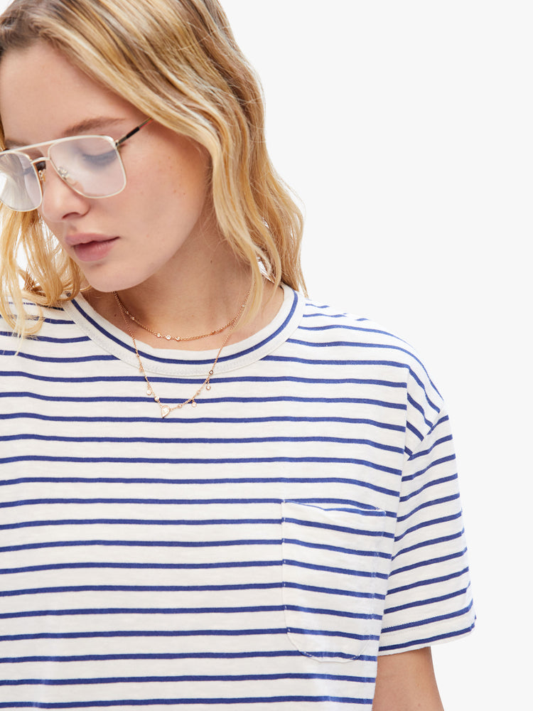 Close up front view of a woman in classic tee from La Paz that is soft and slightly oversized for a loose, comfortable fit, this tee features a white and blue stripe pattern