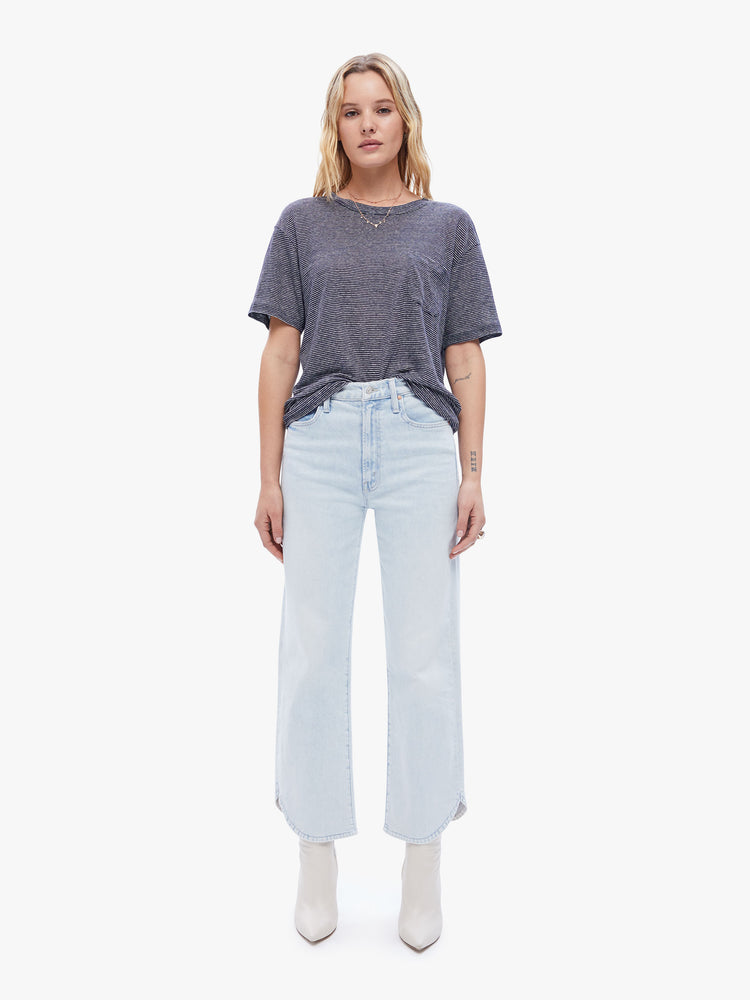 Front full body view a woman in a timeless La Paz tee that is soft and slightly oversized for a loose, comfortable fit cut from 100% linen, this classic crewneck tee features a dark navy stripe pattern