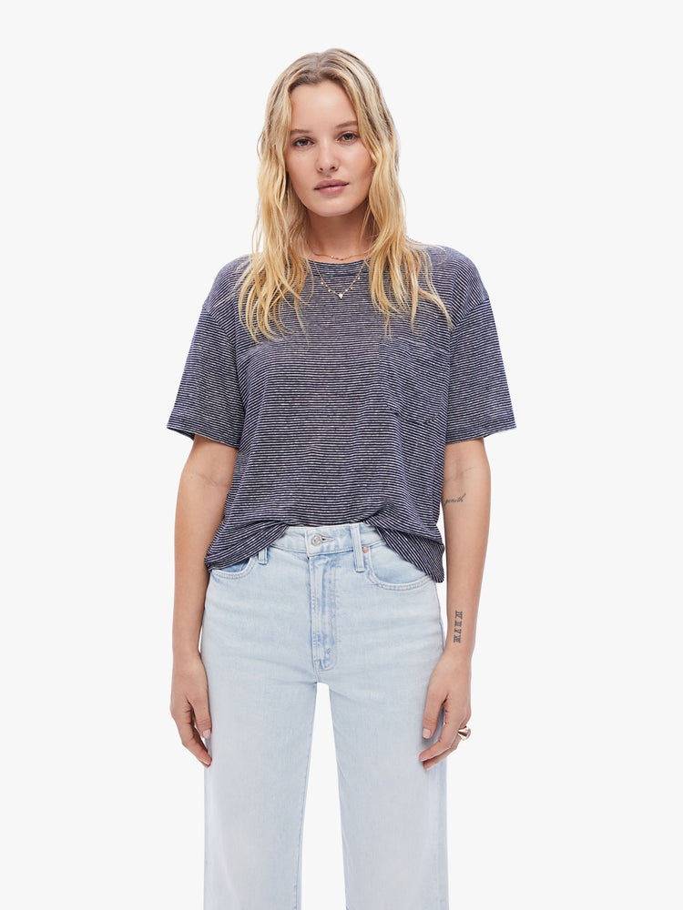 Front view a woman in a timeless La Paz tee that is soft and slightly oversized for a loose, comfortable fit cut from 100% linen, this classic crewneck tee features a dark navy stripe pattern
