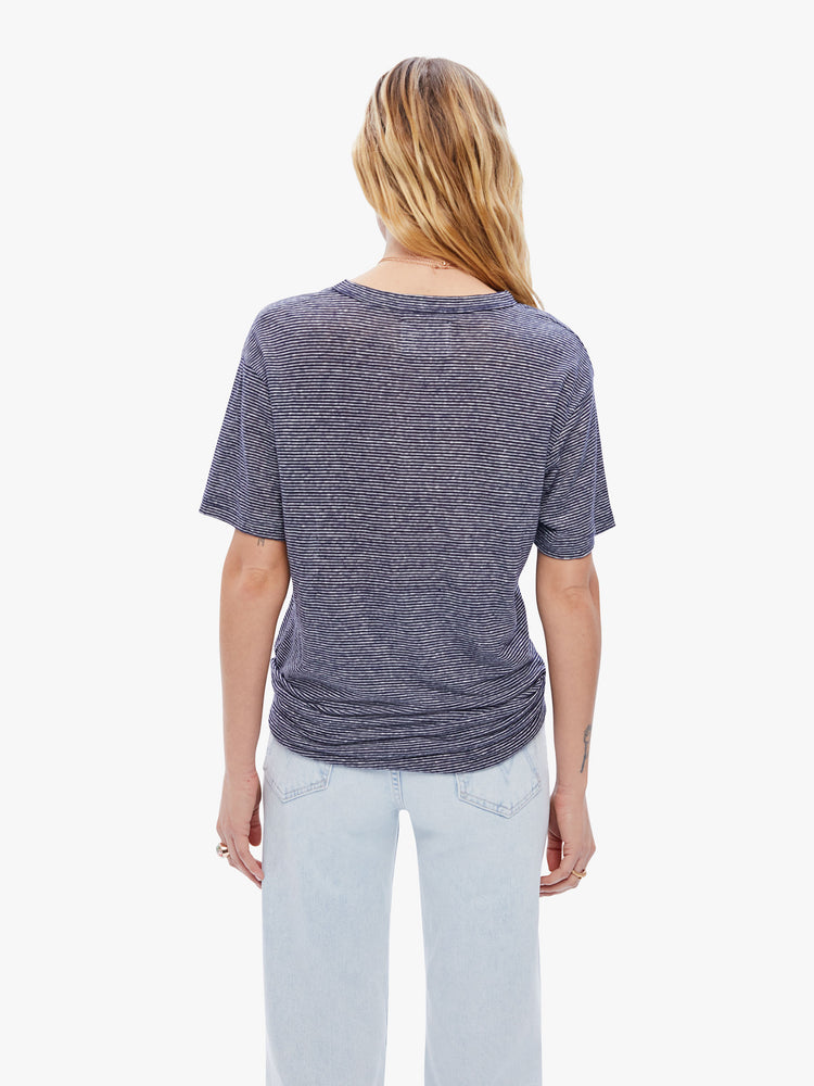Back view a woman in a timeless La Paz tee that is soft and slightly oversized for a loose, comfortable fit cut from 100% linen, this classic crewneck tee features a dark navy stripe pattern
