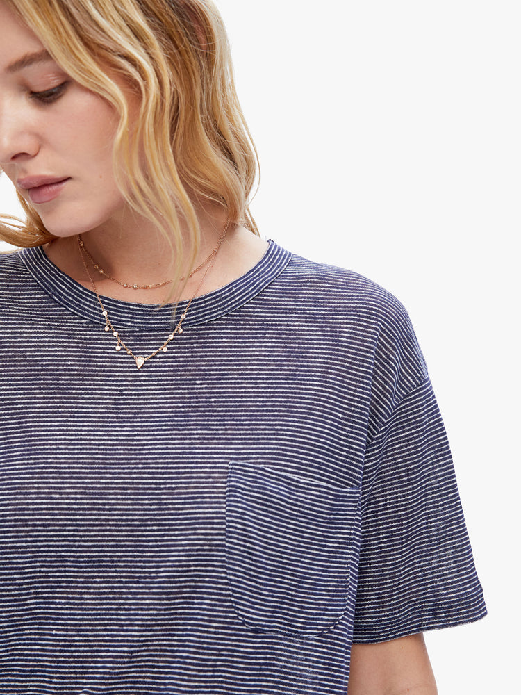 Close up view a woman in a timeless La Paz tee that is soft and slightly oversized for a loose, comfortable fit cut from 100% linen, this classic crewneck tee features a dark navy stripe pattern