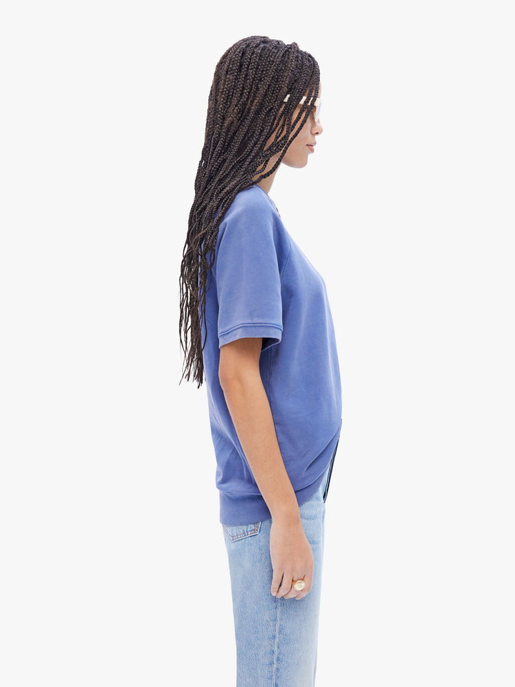 Side view of a woman in a timeless periwinkle blue top from La Paz, this shirt has a ribbed crewneck and a boxy, oversized fit
