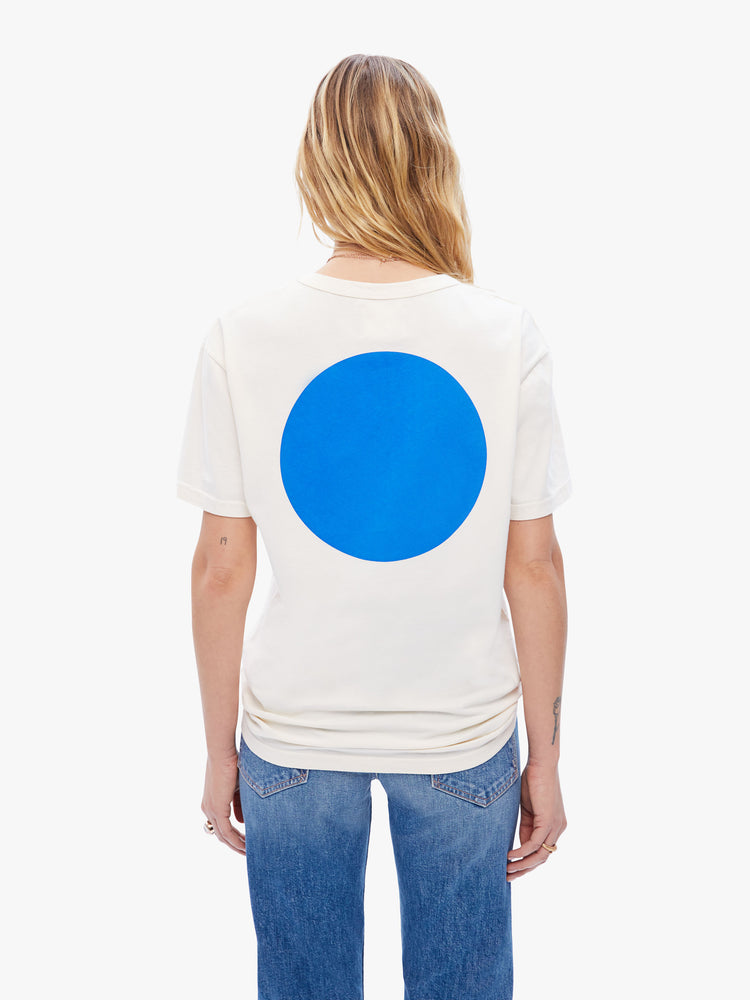 Back view of a woman in classic tee from La Paz, the white classic crewneck tee features the brands logo on the front and a blue circle on the back
