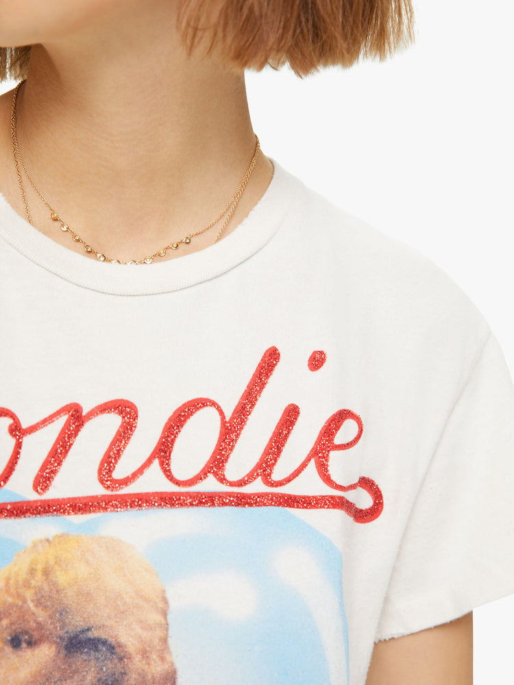 Detail view of a woman wearing an off-white tee with Blondie Heart of Glass graphic