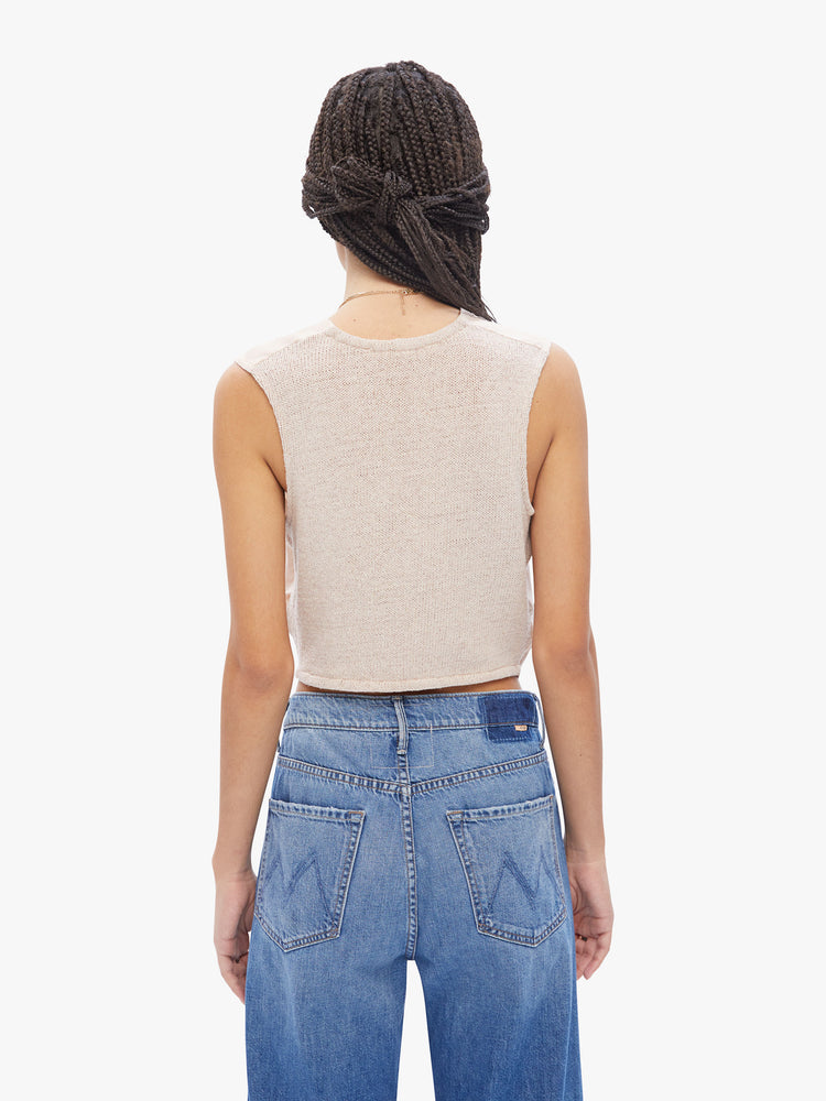 Back view of a woman in Elsa Esturgie a French brand that uses natural fabrics, the intact vest is designed with a Vneck, buttons down the front and a cropped, angle in an off-white hue made from linen and recycled cotton blend