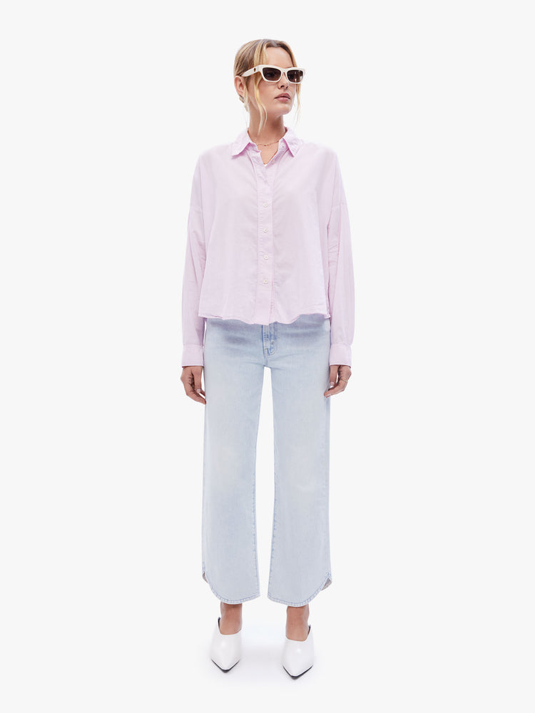 Full body view of a woman in a light pink button down from XiRENA, the long sleeve shirt is light, airy with a loose fit, drop shoulders and a hip-grazing hem