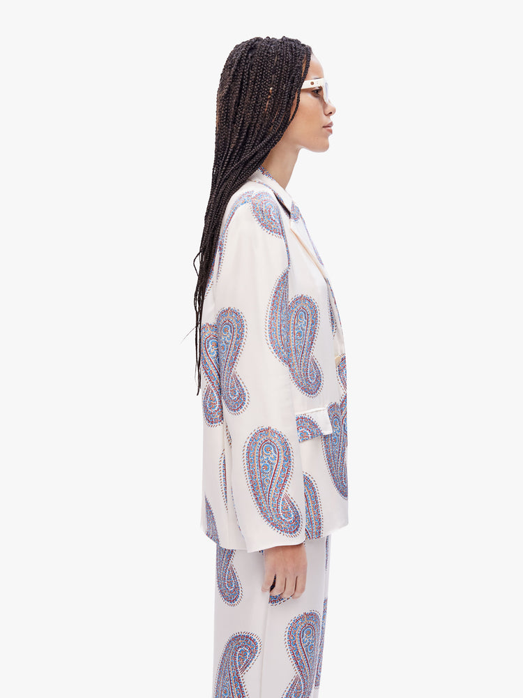 Side view of a woman in a lightweight blazer from XiRENA, made from 100% silk in white with a paisley print and features a notched collar, front pockets, and a loose, breezy fit