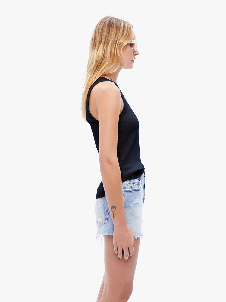 Side view of a woman in a black sleeveless top from XiRENA, tank features a scoop neck, slim fit and hip-grazing hem