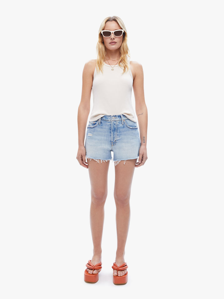 Front full body view of a woman in an ivory sleeveless top from XiRENA, tank features a scoop neck, slim fit and hip-grazing hem