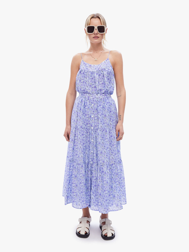 A front full body view of a woman in a maxi skirt from XiRENA made from a blend of cotton and silk in a periwinkle floral print, skirt is designed with an elastic high waist, buttons down the front and a flowy gathered tiers