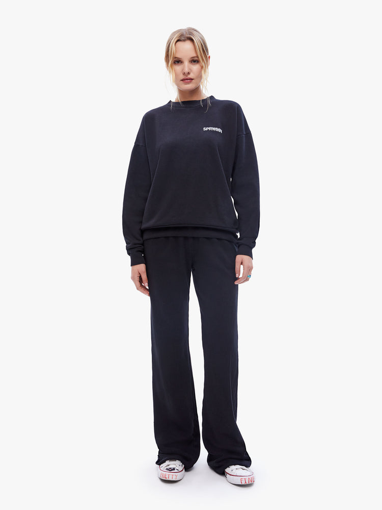 Front full body view of a womens black sweatshirt featuring a crew neck with dropped sleeves and "SPRWMN" printed on the chest.