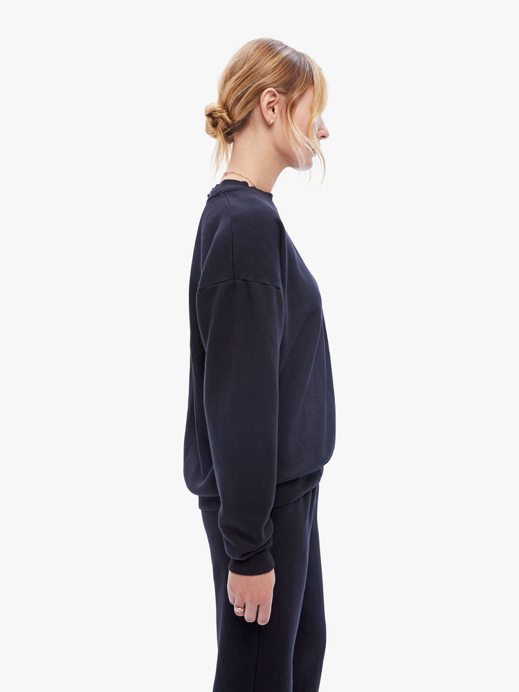 Side view of a womens black sweatshirt featuring a crew neck with dropped sleeves.
