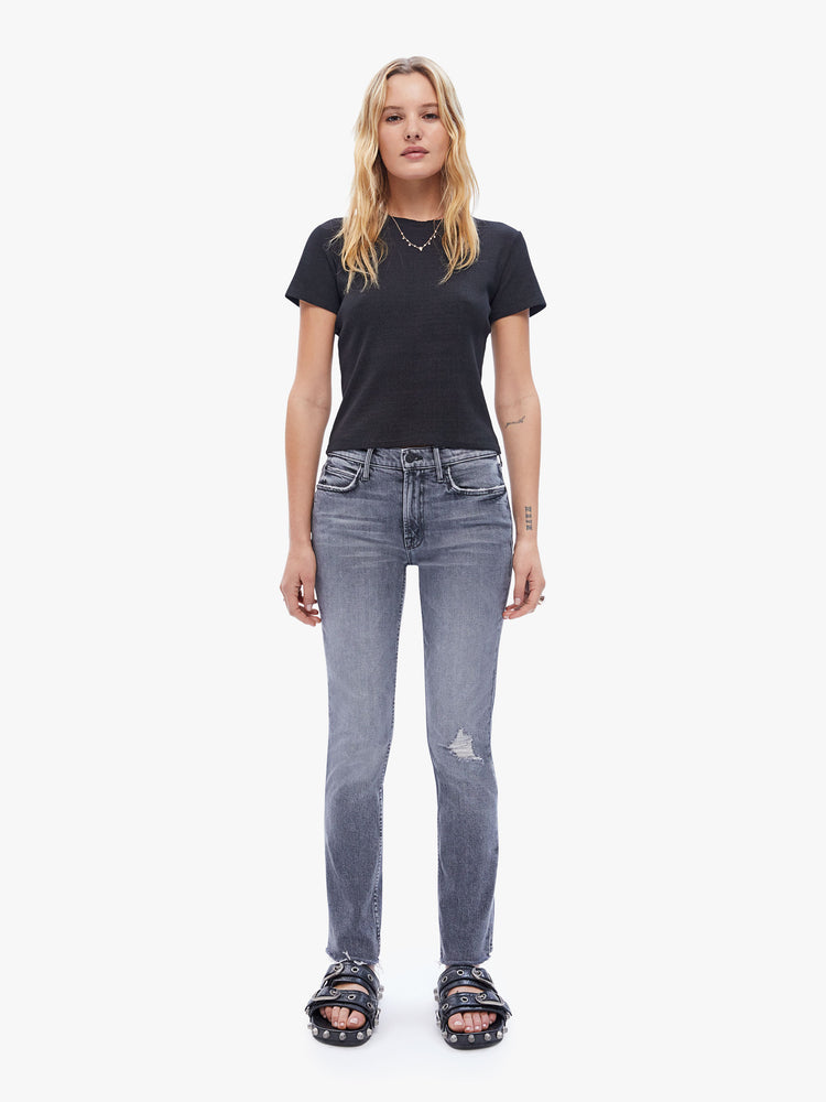 Full body view of a woman in a baby tee from the Los Angeles brand SPRWMN made from a soft stretchy fabric in black the super cozy shirt has a hip length hem, short sleeves and a semi fitted shape