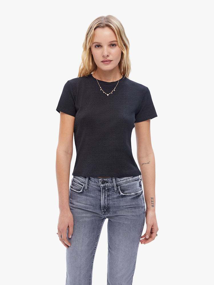 Front view of a woman in a baby tee from the Los Angeles brand SPRWMN made from a soft stretchy fabric in black the super cozy shirt has a hip length hem, short sleeves and a semi fitted shape