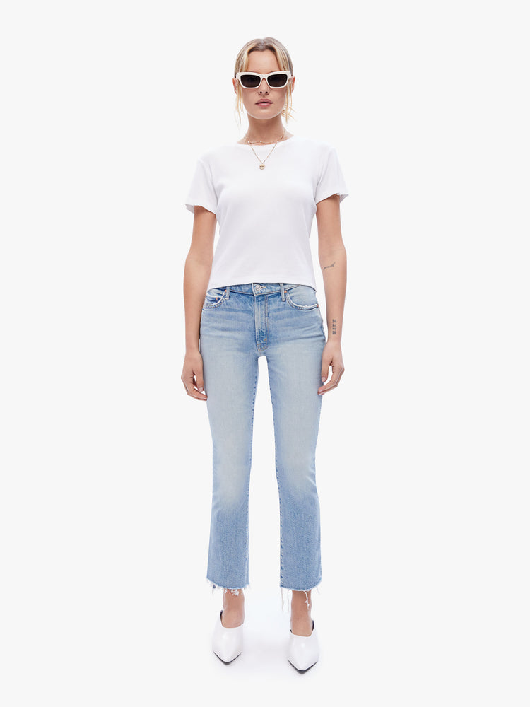 Full body view of a woman in a baby tee from the Los Angeles brand SPRWMN made from a soft stretchy fabric in white the super cozy shirt has a hip length hem, short sleeves and a semi fitted shape