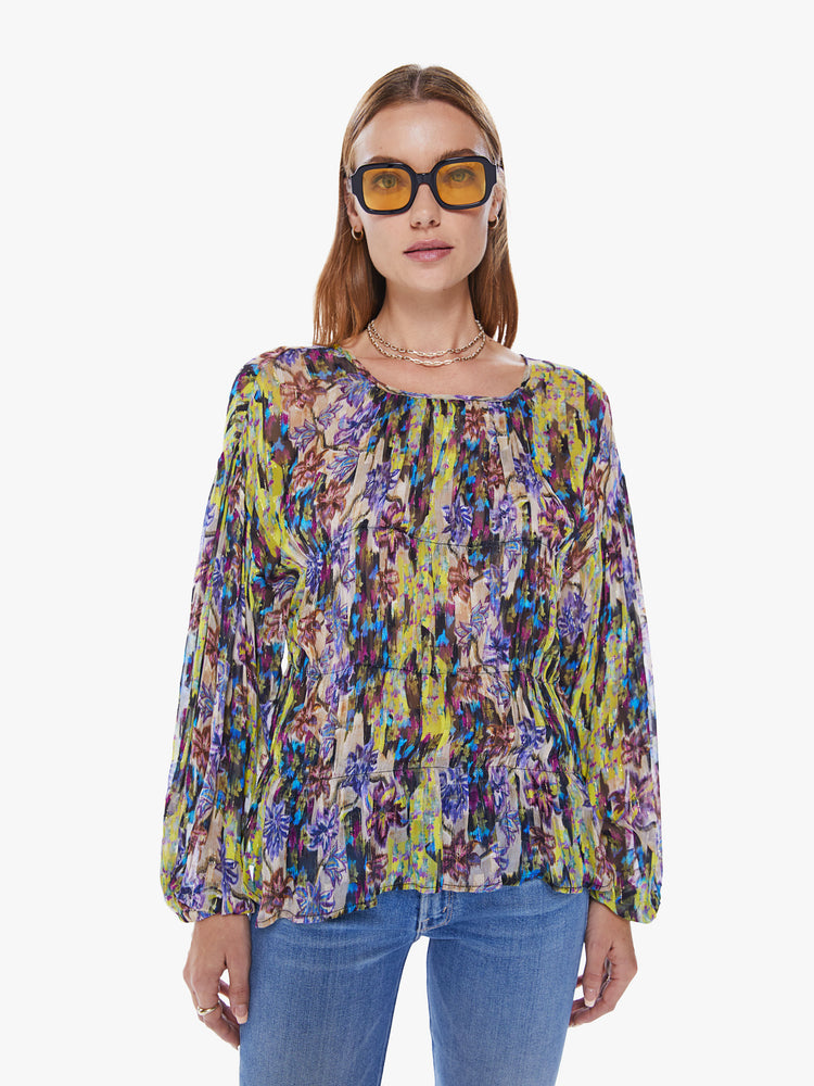 Front view of a woman in a Maria Cher long sleeve top designed in a bright yellow and purple abstract print, the long sleeve blouse features a crewneck, balloon sleeves and a loose, flowy fit
