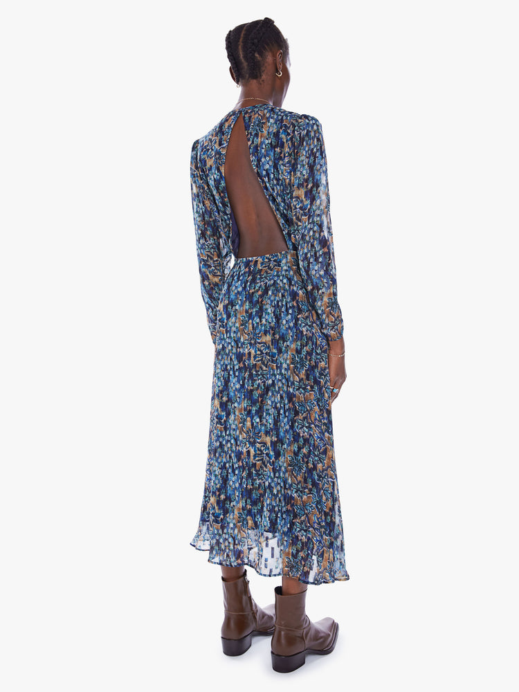 Back view full body view of a woman in blue floral print midi dress by Maria Cher that features a V-neck, gathered bodice, puffed shoulders and slightly cropped long sleeves