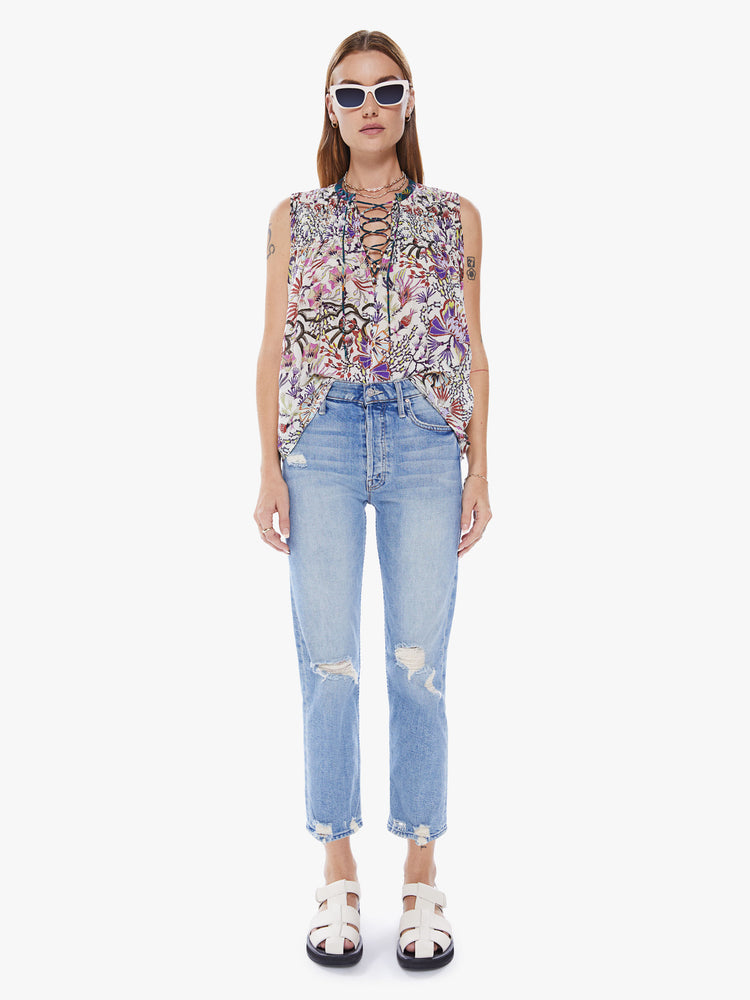 Full body view of a woman in a Maria Cher blouse with bold prints and modern neutrals, made from a blend of cotton and silk in a colorful abstract floral print, the sleeveless blouse features a deep Vneck that laces and ties, a hip grazing hem and a loose, flowy fit
