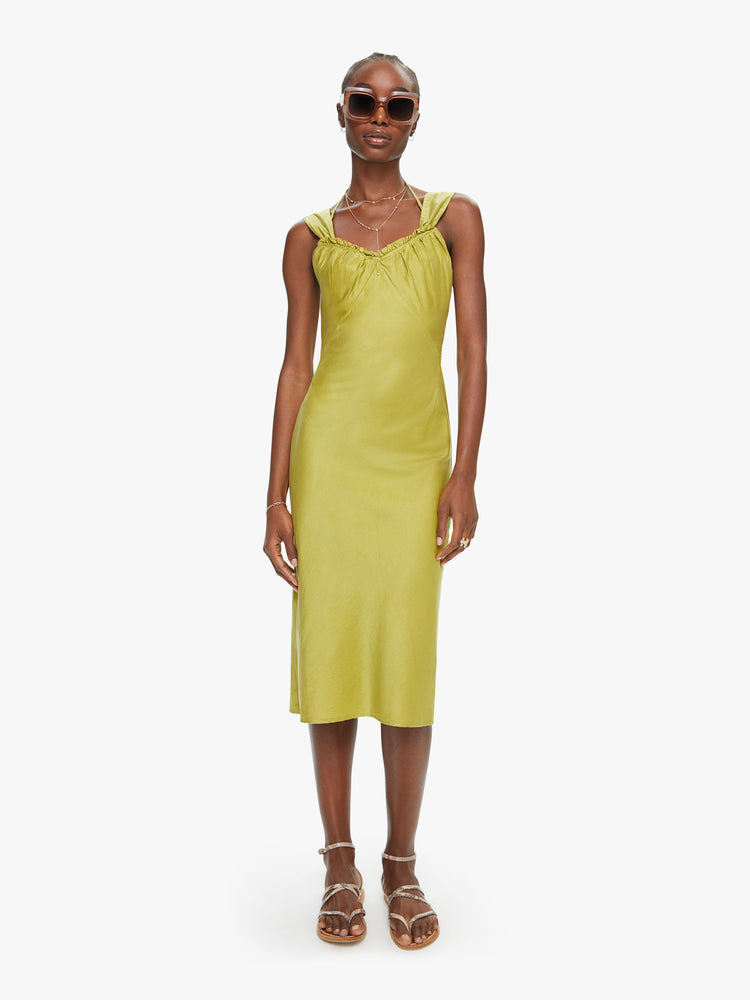 Front view of a woman a chartreuse hue dress, and features a gathered neckline, thick straps, a slim fit and midi-length hem.