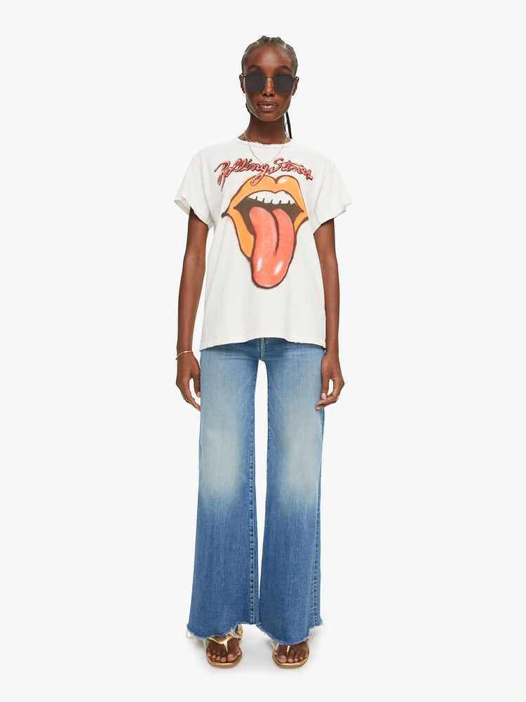Full body view crewneck tee by MadeWorn with a relaxed fit. Made of 100% cotton in white, the tee pays homage to the Rolling Stones with an airbrushed graphic of the band's iconic tongue-and-lips logo on the front.