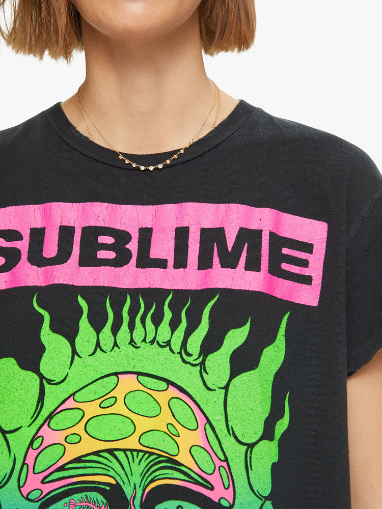 Close up view hand-distressed crewneck tee by MadeWorn with a relaxed fit. Made of 100% cotton in black, the tee honors Sublime with the band's sun graphic on the front in bright neon hues.