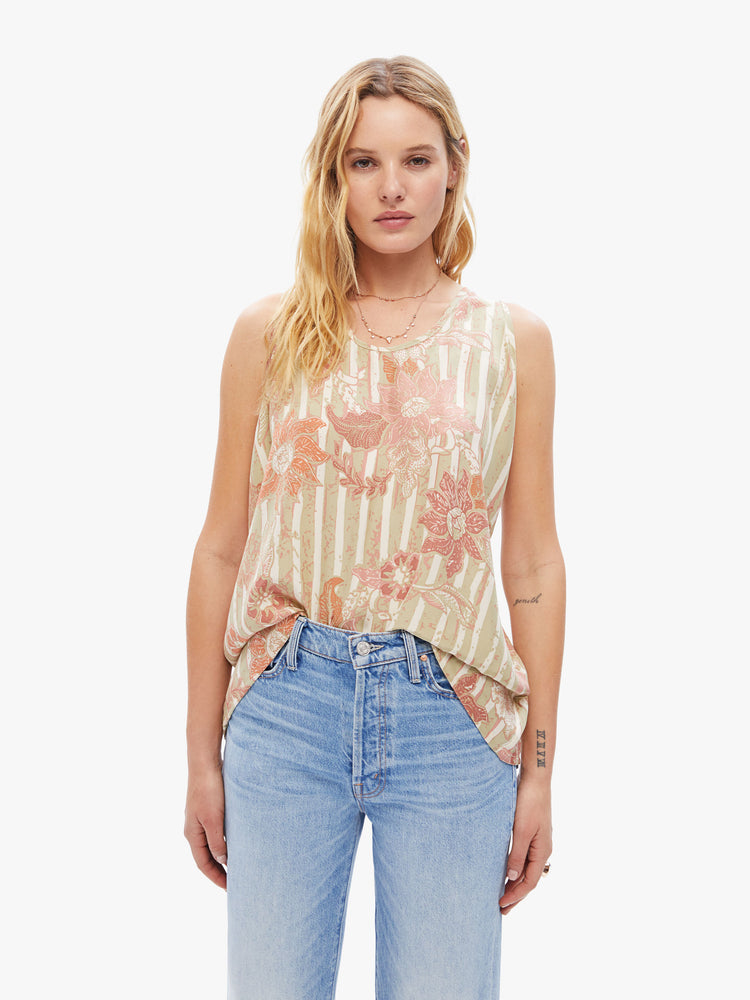 Front view of woman  hip-grazing hem and a loose, boxy fit tank in a tan stripe pattern with warm-toned sunflowers.