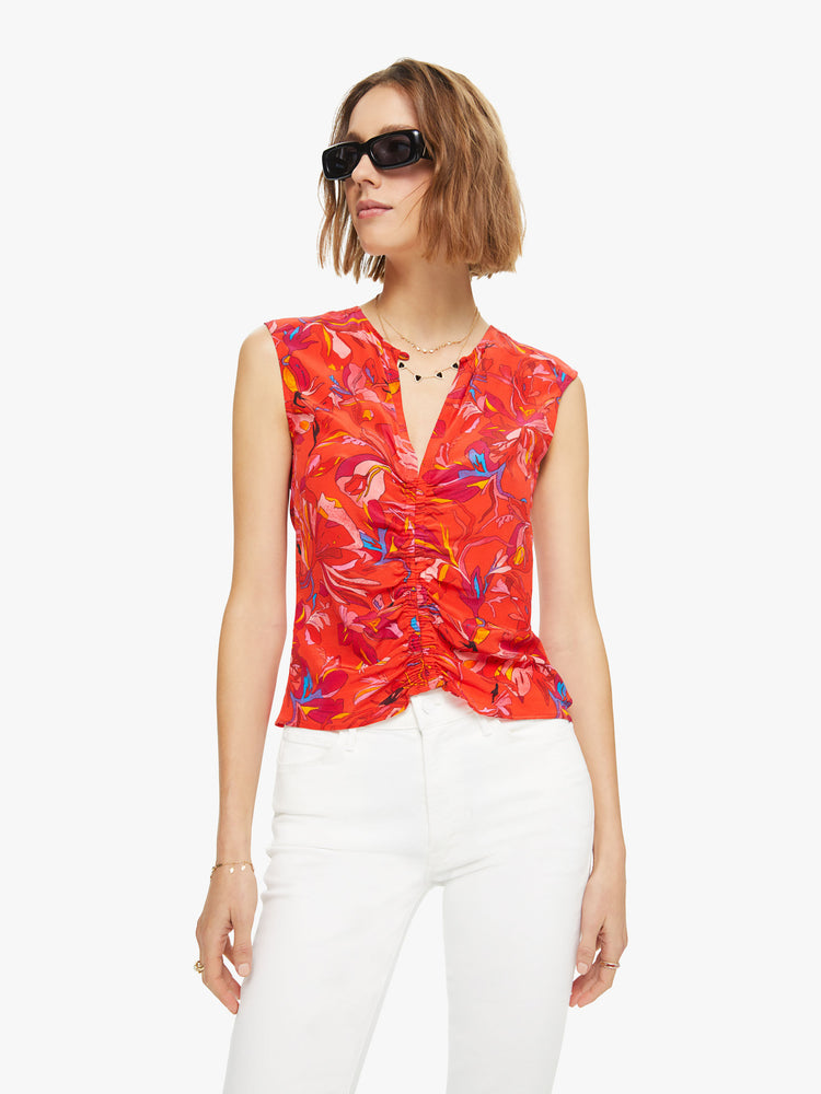 Front view of a woman sleeveless top  in a red, blue and yellow abstract print, and features a V-neck, gathered seam down the front and a slim fit.