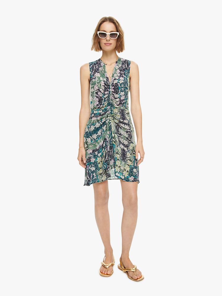 Front view of woman's sleeveless mini dress in a blue, green, and yellow abstract print with a slim fit.