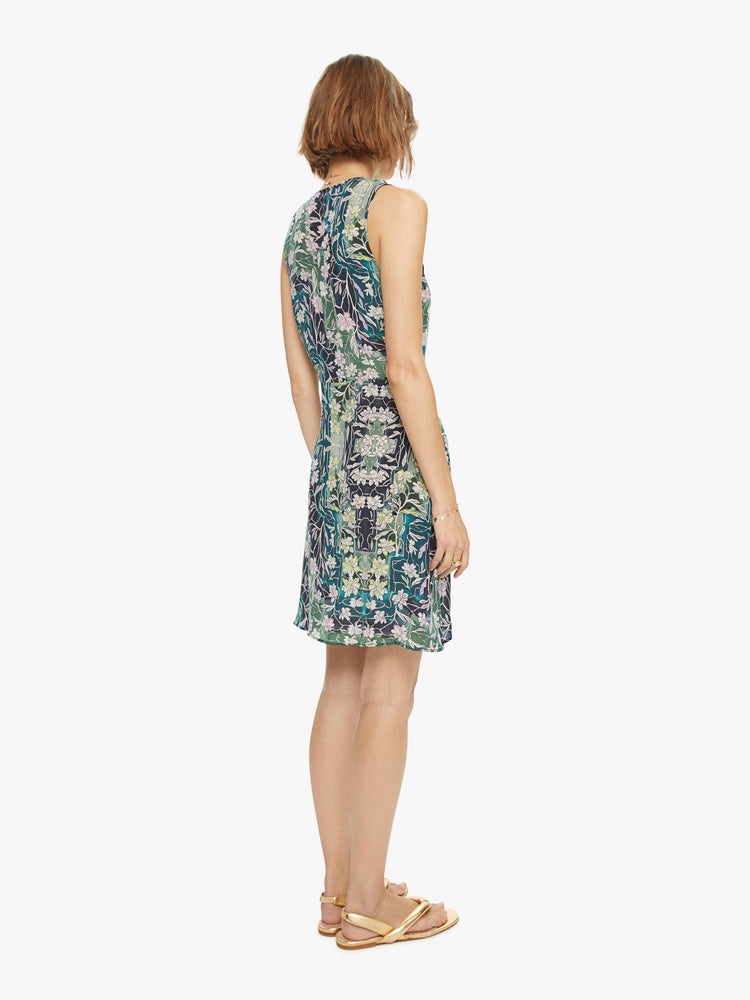 Back view of woman's sleeveless mini dress in a blue, green, and yellow abstract print with a slim fit.