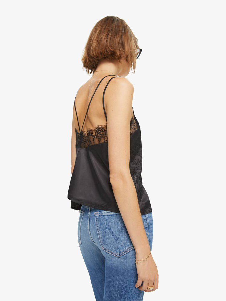 Back view of a woman black lace top with V-neck , buttons down the front and spaghetti straps.