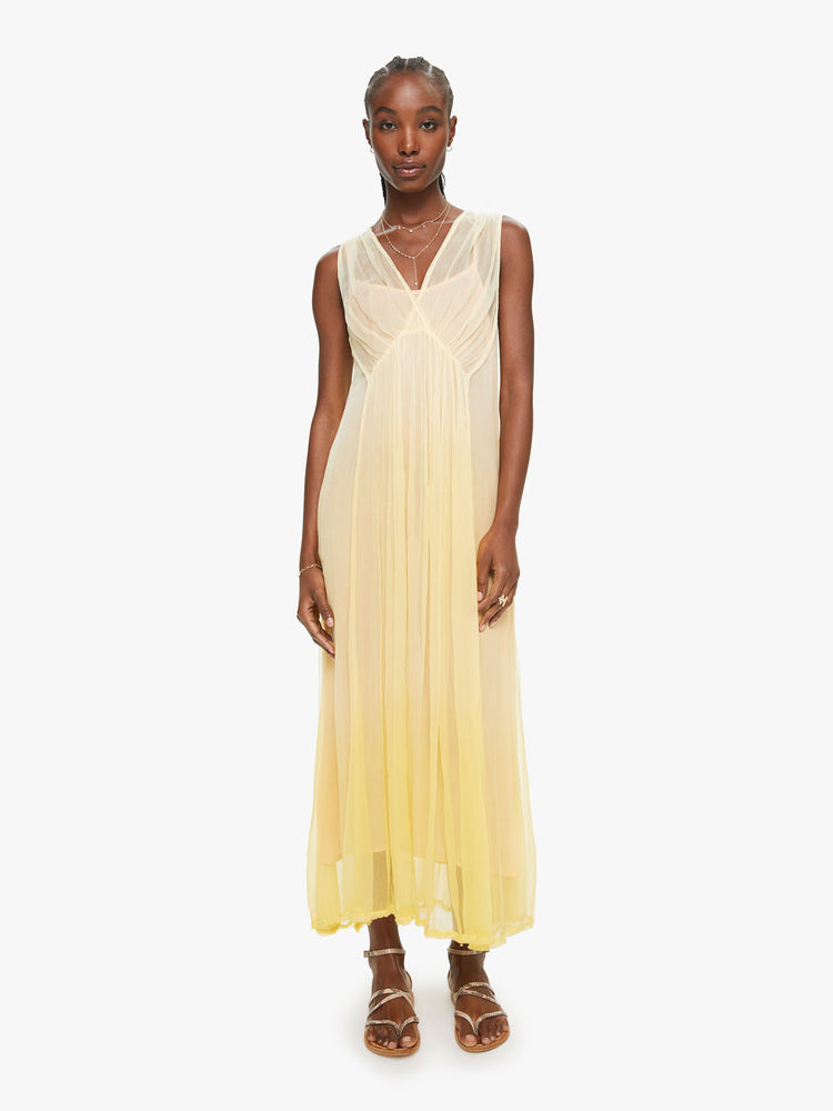 Front view of a woman yellow ombre hue maxi dress with Vneck and uneven hem.
