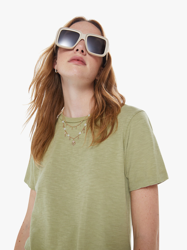 Close up view of a woman in a classic crewneck from American heritage brand Velva Sheen with a slightly boxy shop, crafted from 100% cotton this sage green tee gets better every wear