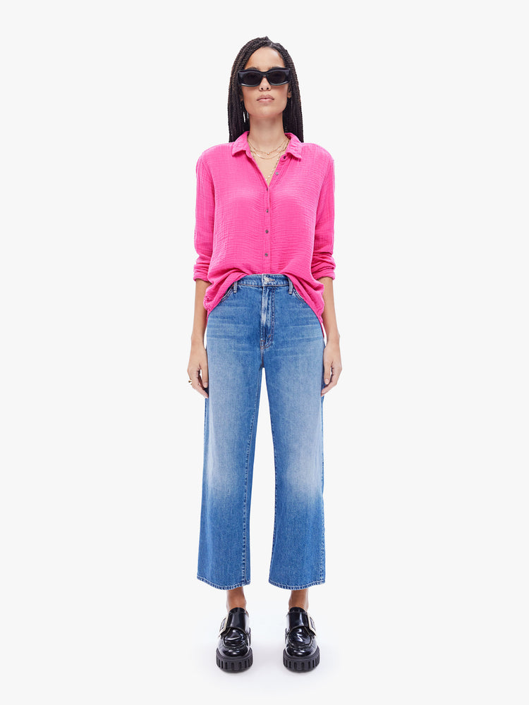 Full body view of a woman in hot pink button down from XiRENA made from 100% cotton, the long sleeve shirt features a Vneck and curved hem with a light and airy fit