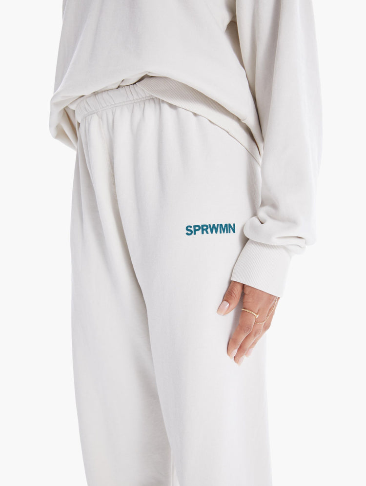 DETAIL  VIEW WOMEN'S OFF WHITE SWEATPANTS WITH BLUE LETTERING