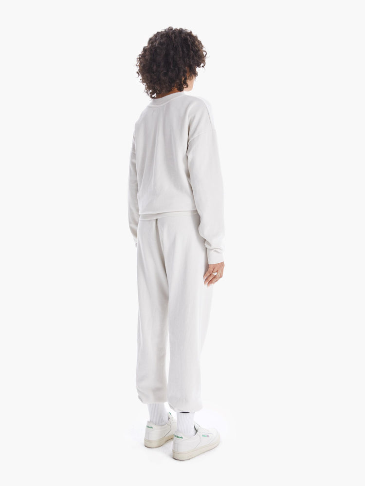 BACK VIEW WOMEN'S OFF WHITE SWEATPANTS WITH BLUE LETTERING
